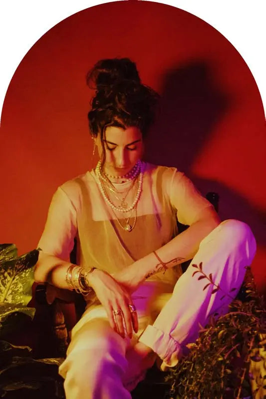 Atafeh Karimi, founder of A.K.A, seated among plants