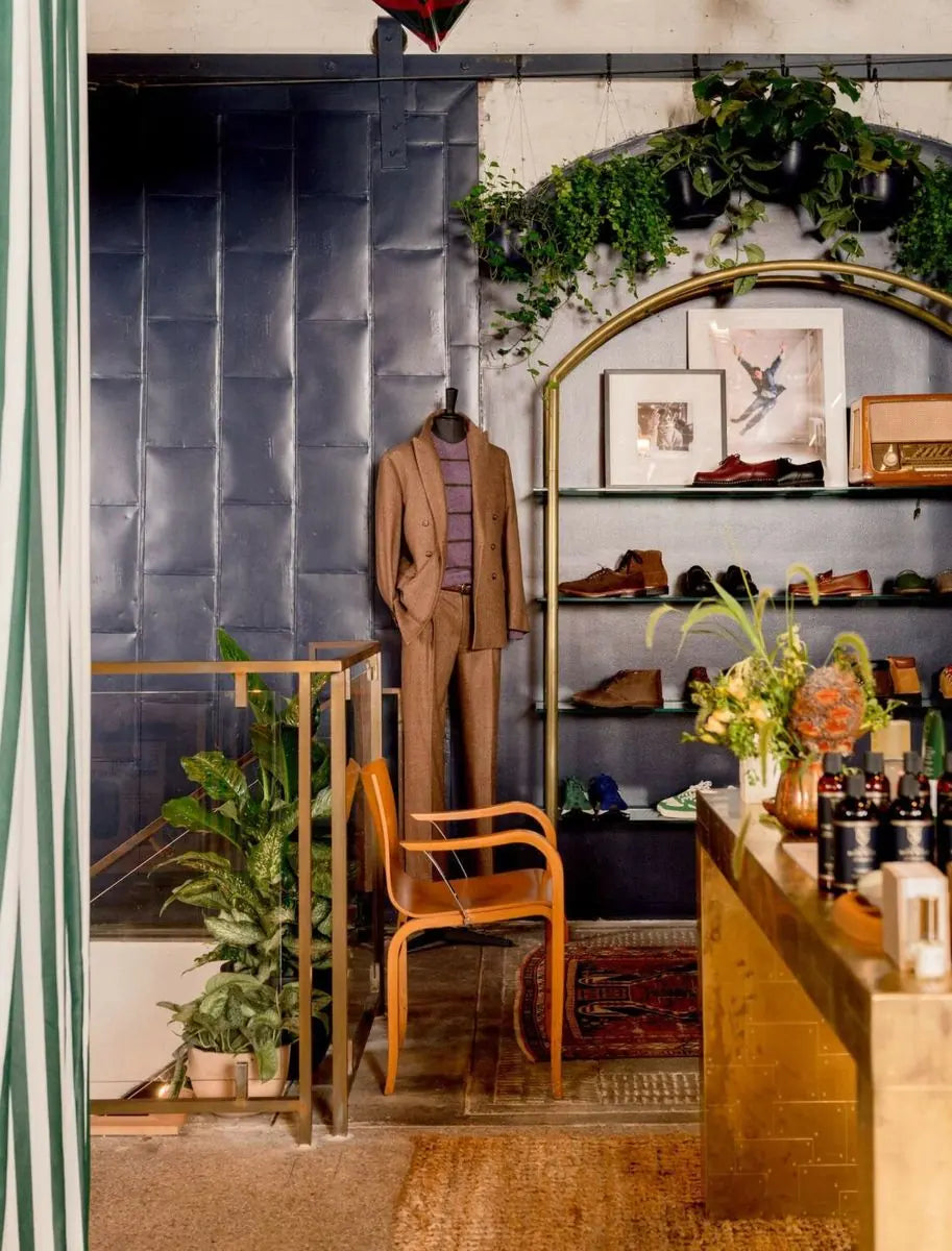 Trailing greenery and potted foliage woven into a richly layered retail interior