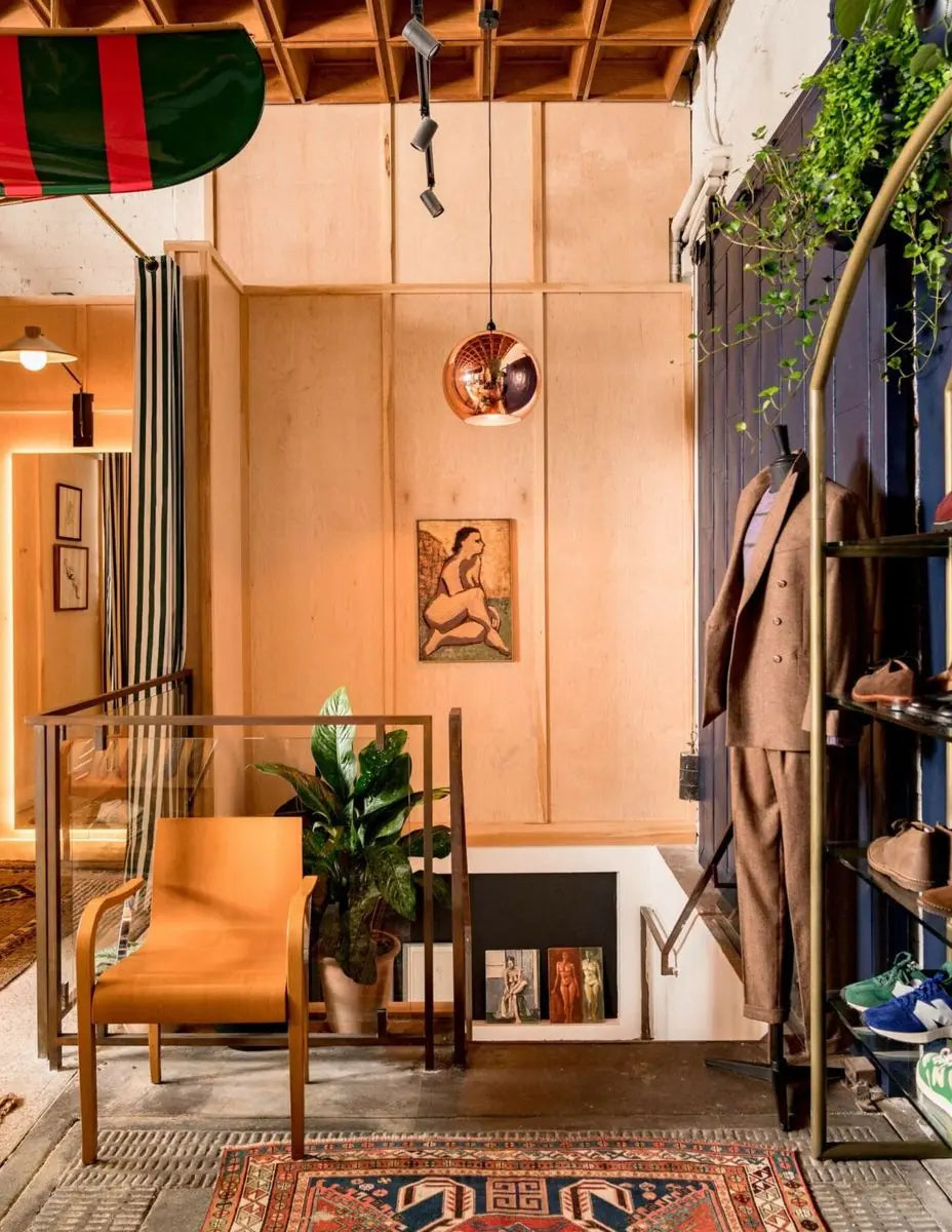 Warm terracotta interior with climbing greenery and a planted stair